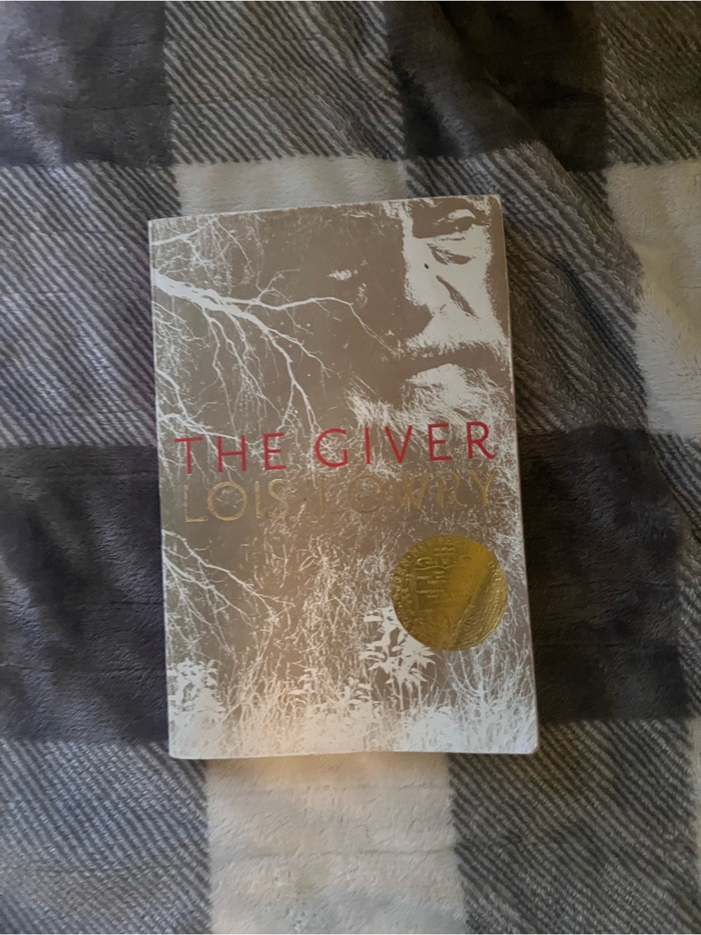 The Giver paperback book - white and gold cover